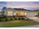 Charming single-story home featuring a well-manicured lawn and neutral color palette exterior at 9728 Sw 95Th Loop, Ocala, FL 34481