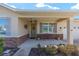 Inviting front porch featuring stone accents, a charming bench, and a welcoming entrance at 9728 Sw 95Th Loop, Ocala, FL 34481