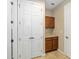 Large hall laundry room features folding counter and storage at 9728 Sw 95Th Loop, Ocala, FL 34481