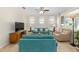 Cozy living room with plush sofas, a ceiling fan, and large windows at 9728 Sw 95Th Loop, Ocala, FL 34481