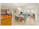 Open-concept living and kitchen area with tile flooring and a stylish dining set at 9728 Sw 95Th Loop, Ocala, FL 34481