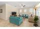 Bright living room features a ceiling fan, large windows, and comfortable seating at 9728 Sw 95Th Loop, Ocala, FL 34481