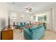 Well-lit living room showcasing sofas, ceiling fan, and large window with natural light at 9728 Sw 95Th Loop, Ocala, FL 34481