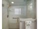 Modern bathroom showcasing a glass-enclosed shower and contemporary fixtures at 16751 Se 84Th Colerain Cir, The Villages, FL 32162
