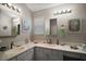 Well-lit bathroom with dual sinks, decorative fixtures, and ample counter space at 16751 Se 84Th Colerain Cir, The Villages, FL 32162