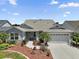 Charming single-story home featuring well-maintained landscaping, a two-car garage, and a welcoming front entrance at 16751 Se 84Th Colerain Cir, The Villages, FL 32162