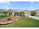 Charming home showcasing beautiful landscaping, a well-manicured lawn, and a welcoming front entrance at 16751 Se 84Th Colerain Cir, The Villages, FL 32162