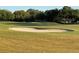 Scenic golf course view featuring lush green grass and challenging sand traps at 16751 Se 84Th Colerain Cir, The Villages, FL 32162