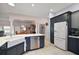 Spacious kitchen with stainless appliances, modern cabinetry, and an open layout to the dining and living areas at 16751 Se 84Th Colerain Cir, The Villages, FL 32162