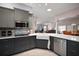Stylish kitchen featuring stainless steel appliances, a breakfast bar, and open views to the living area at 16751 Se 84Th Colerain Cir, The Villages, FL 32162