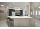 Open-concept kitchen with a breakfast bar, modern cabinetry, stainless steel appliances, and tile flooring at 16751 Se 84Th Colerain Cir, The Villages, FL 32162