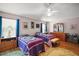 Comfortable bedroom featuring two beds, hardwood floors, a ceiling fan, and neutral walls at 16751 Se 84Th Colerain Cir, The Villages, FL 32162