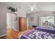 Spacious main bedroom with hardwood flooring, two beds, and private exterior access to a lanai at 16751 Se 84Th Colerain Cir, The Villages, FL 32162