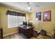 Dedicated home office space featuring a large window for natural light and wood flooring at 16751 Se 84Th Colerain Cir, The Villages, FL 32162