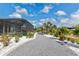 Well-maintained backyard features gravel, manicured landscaping, white rock, and a screened pool, creating a serene and inviting outdoor space at 10293 Sw 96Th Ln, Ocala, FL 34481