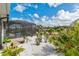 Lush backyard features vibrant landscaping, a screened pool enclosure, and a tranquil outdoor space for relaxation and enjoyment at 10293 Sw 96Th Ln, Ocala, FL 34481