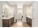 This neutral bathroom has dual vanities with dark wood cabinets and a bright, clean aesthetic with lots of walking room at 10293 Sw 96Th Ln, Ocala, FL 34481
