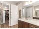 This bathroom features a modern vanity with drawers and white countertop, a large mirror, and opens to the walk-in closet at 10293 Sw 96Th Ln, Ocala, FL 34481