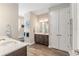 This bathroom features dual vanities with dark wood cabinets and neutral walls, creating a serene space at 10293 Sw 96Th Ln, Ocala, FL 34481