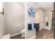 Half bathroom with decorative painting and dark wood-look flooring at 10293 Sw 96Th Ln, Ocala, FL 34481