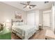 Bedroom with view of ensuite bath and a ceiling fan at 10293 Sw 96Th Ln, Ocala, FL 34481