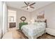 Bedroom with light-green patterned bedding and ensuite bath at 10293 Sw 96Th Ln, Ocala, FL 34481
