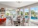 Bright dining room featuring a round table and chairs, with views of the pool and outdoor space at 10293 Sw 96Th Ln, Ocala, FL 34481