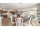 Open-concept dining room with stylish chandelier, seamlessly connected to the kitchen and living area at 10293 Sw 96Th Ln, Ocala, FL 34481