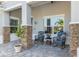 Inviting front porch with stone accents, decorative seating, and a tranquil outdoor ambiance at 10293 Sw 96Th Ln, Ocala, FL 34481