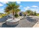 Landscaped front yard featuring gravel and a paver driveway leading up to a single Gathering home with a two-car garage at 10293 Sw 96Th Ln, Ocala, FL 34481