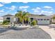 Inviting home boasting a landscaped front yard with palm trees, a brick driveway, and a two-car garage at 10293 Sw 96Th Ln, Ocala, FL 34481
