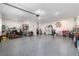 Large garage with plenty of storage space, featuring an epoxy floor and multiple storage cabinets at 10293 Sw 96Th Ln, Ocala, FL 34481