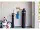 Garage interior featuring a water filtration system, and storage for cleaning supplies and other equipment at 10293 Sw 96Th Ln, Ocala, FL 34481