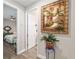 Hallway with access to bedroom and decorative landscape painting at 10293 Sw 96Th Ln, Ocala, FL 34481