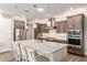 Well-lit kitchen showcasing a central island, stainless steel appliances, and ample cabinet space at 10293 Sw 96Th Ln, Ocala, FL 34481