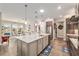 Open kitchen with island, seamless flow to dining area and pool views enhance indoor/outdoor living at 10293 Sw 96Th Ln, Ocala, FL 34481