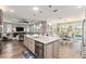 Bright, open kitchen features a large island with granite countertops and stainless steel appliances, flowing into dining and living areas at 10293 Sw 96Th Ln, Ocala, FL 34481