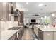 Open-concept kitchen leading into a living area, featuring a large island and modern appliances at 10293 Sw 96Th Ln, Ocala, FL 34481