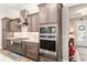 Beautiful kitchen with stainless steel appliances, modern oven and custom range hood at 10293 Sw 96Th Ln, Ocala, FL 34481