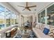 Bright living room with large windows, ceiling fan, and comfortable seating at 10293 Sw 96Th Ln, Ocala, FL 34481