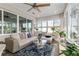 Cozy sunroom featuring a sectional couch, lots of windows, and an inviting seating area at 10293 Sw 96Th Ln, Ocala, FL 34481