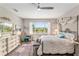 Cozy main bedroom boasts abundant natural light, stylish furnishings, and an inviting atmosphere, perfect for relaxation at 10293 Sw 96Th Ln, Ocala, FL 34481