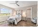 Relaxing main bedroom features a comfortable bed, a ceiling fan, a window with natural light and an ensuite bathroom at 10293 Sw 96Th Ln, Ocala, FL 34481