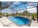 Large, enclosed pool with ample seating and lush landscaping at 10293 Sw 96Th Ln, Ocala, FL 34481