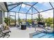 Relaxing screened-in pool area with lounge chairs and a serene outdoor space at 10293 Sw 96Th Ln, Ocala, FL 34481