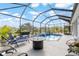 Enclosed pool area with comfortable seating and beautifully landscaped surroundings at 10293 Sw 96Th Ln, Ocala, FL 34481