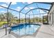 Sparkling blue pool with a screened-in lanai and manicured landscaping at 10293 Sw 96Th Ln, Ocala, FL 34481