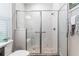 Shower with glass doors, bench, and marble tile at 10293 Sw 96Th Ln, Ocala, FL 34481
