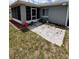 Exterior backyard features a small patio and a well-manicured lawn at 10315 Sw 62Nd Terrace Rd, Ocala, FL 34476