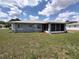 Exterior home view showcasing manicured lawn, patio, and screened-in lanai at 10315 Sw 62Nd Terrace Rd, Ocala, FL 34476
